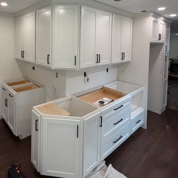 Kitchen renovation with new cabinets set and the outlet and appliance circuits roughed in before the counters go on
